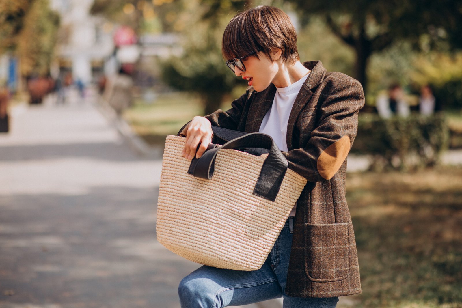 Young beautiful woman with bag outside the street